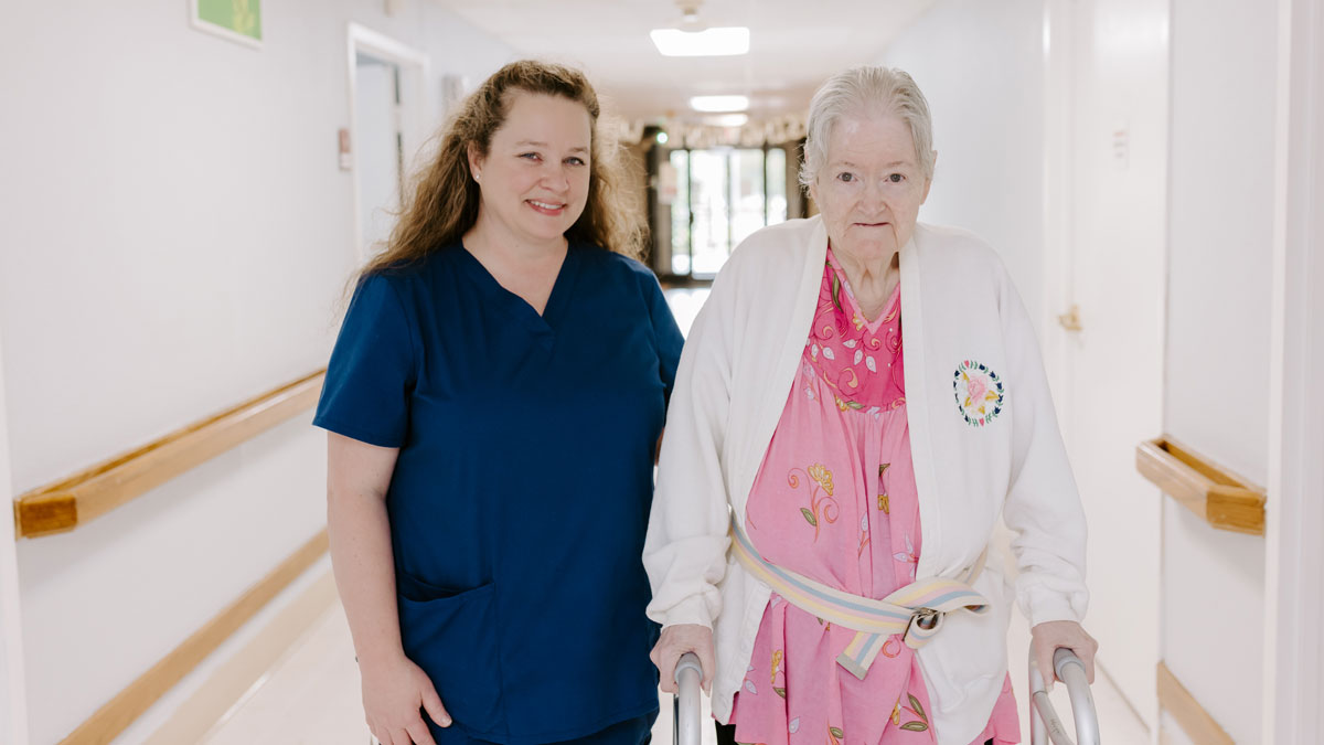 Staff and Elder at Rogers Health and Rehabilitation Center